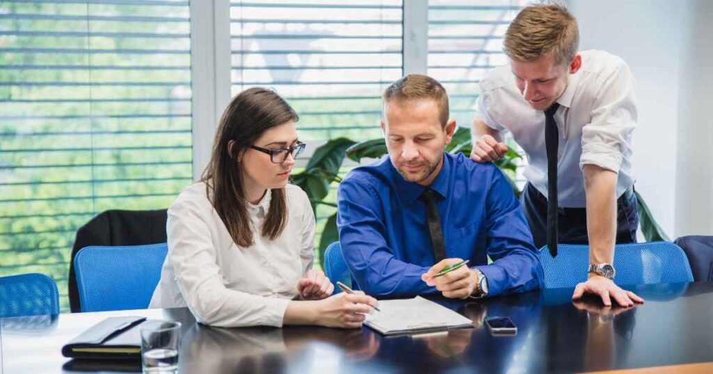 health insurance broker in Knoxville speaking to an employer in a meeting room